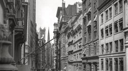 New York circa 1910. View down Wall Street to Trinity Church.